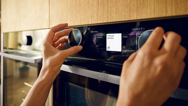 Sleek modern kitchen oven with user-friendly control panel, part of Broadoak Kitchens bespoke kitchen designs.