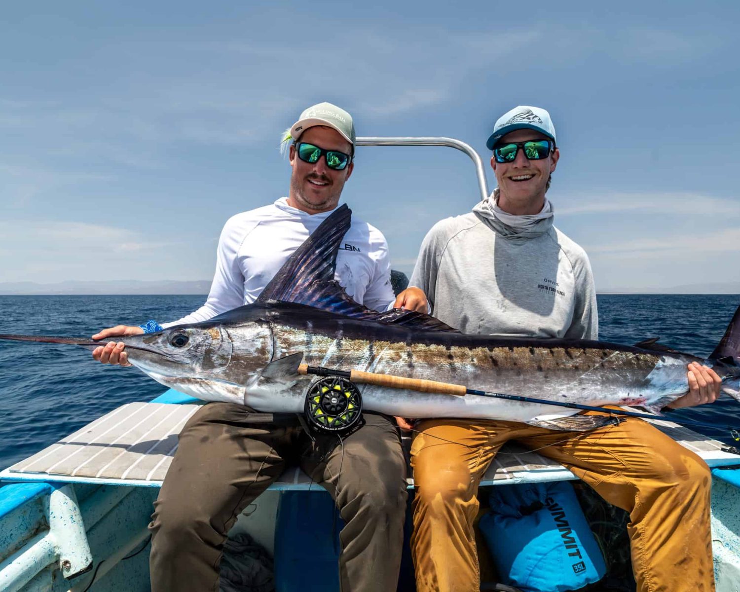 Fly fisherman holding a marlin caught in baja mexico