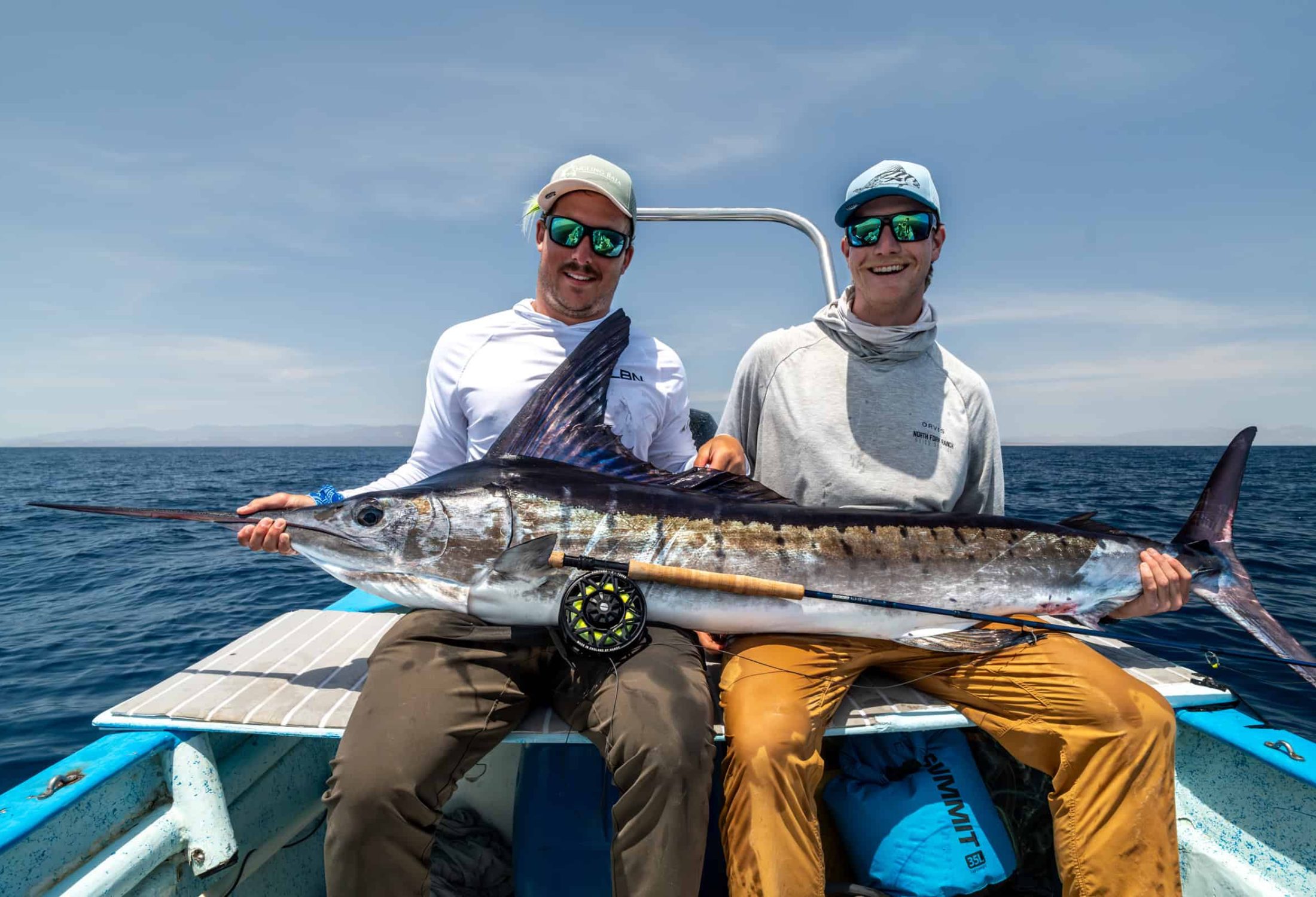 Fly fisherman holding a marlin caught in baja mexico