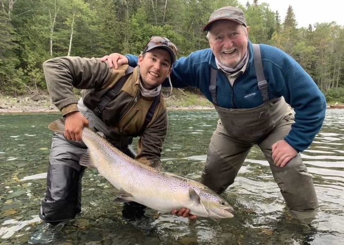 two anglers showing off big gaspé salmon