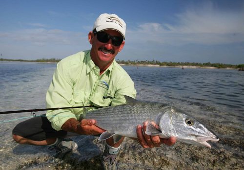 angler holding bonefish on cuba fly fishing trip