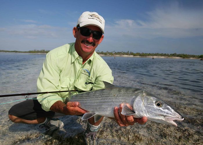 angler holding bonefish on cuba fly fishing trip