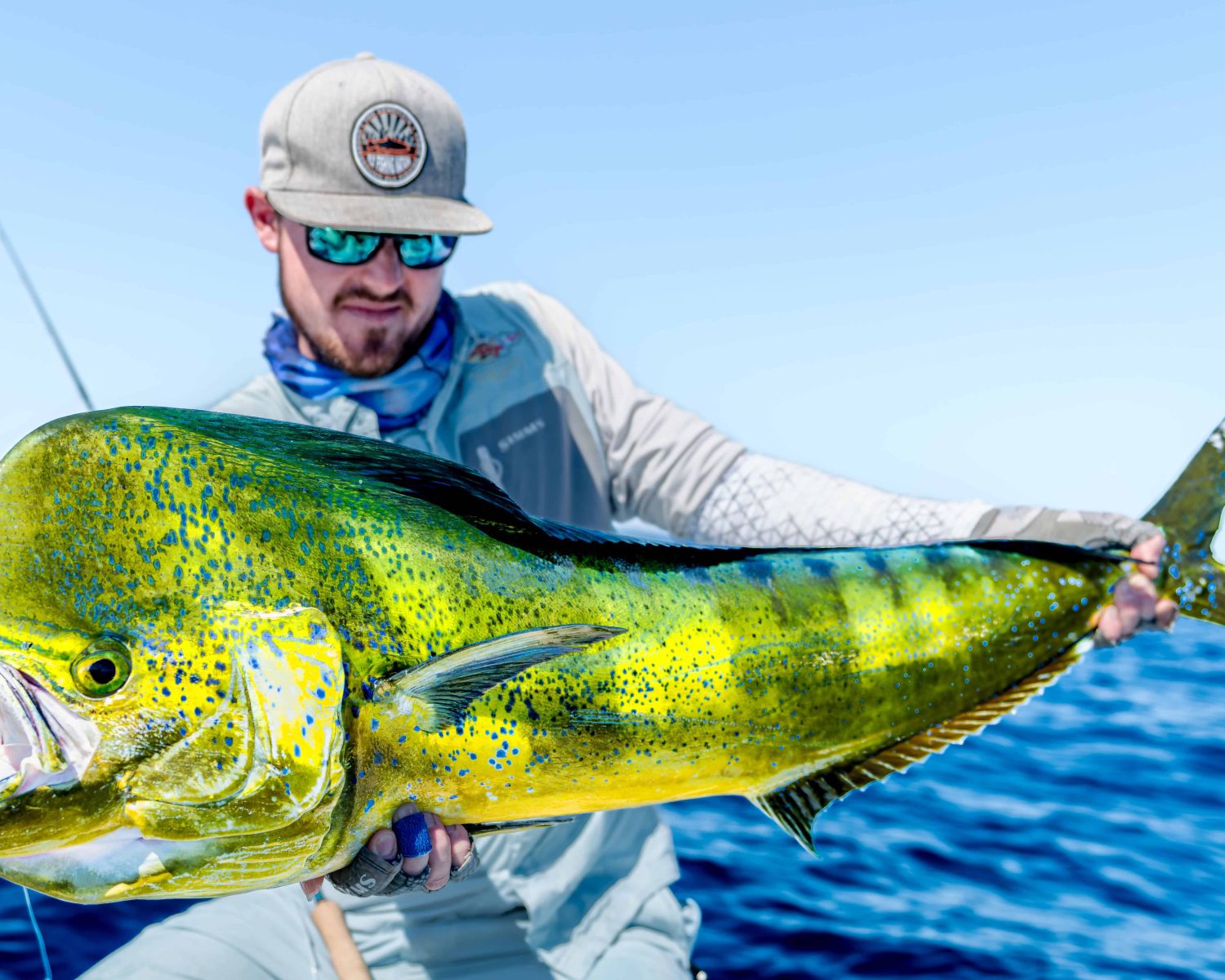 Fly fisherman holding a dorado caught in baja mexico
