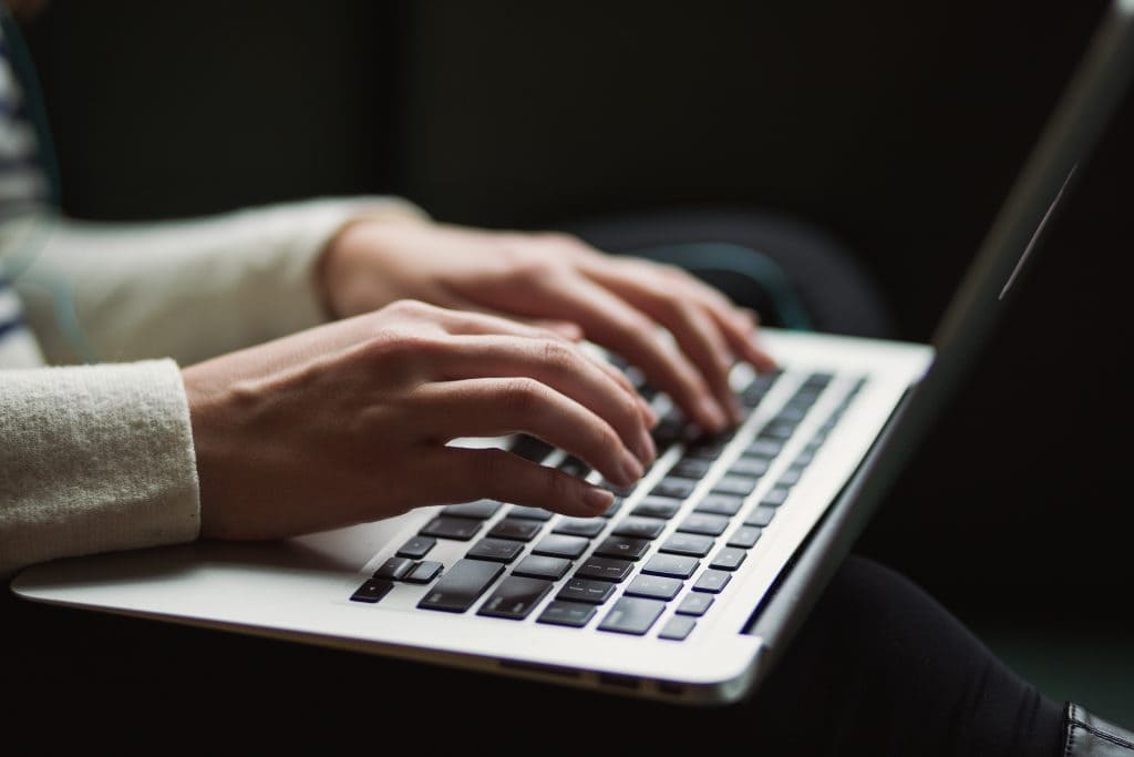 A laptop with a man setting up an LLC under a personal name