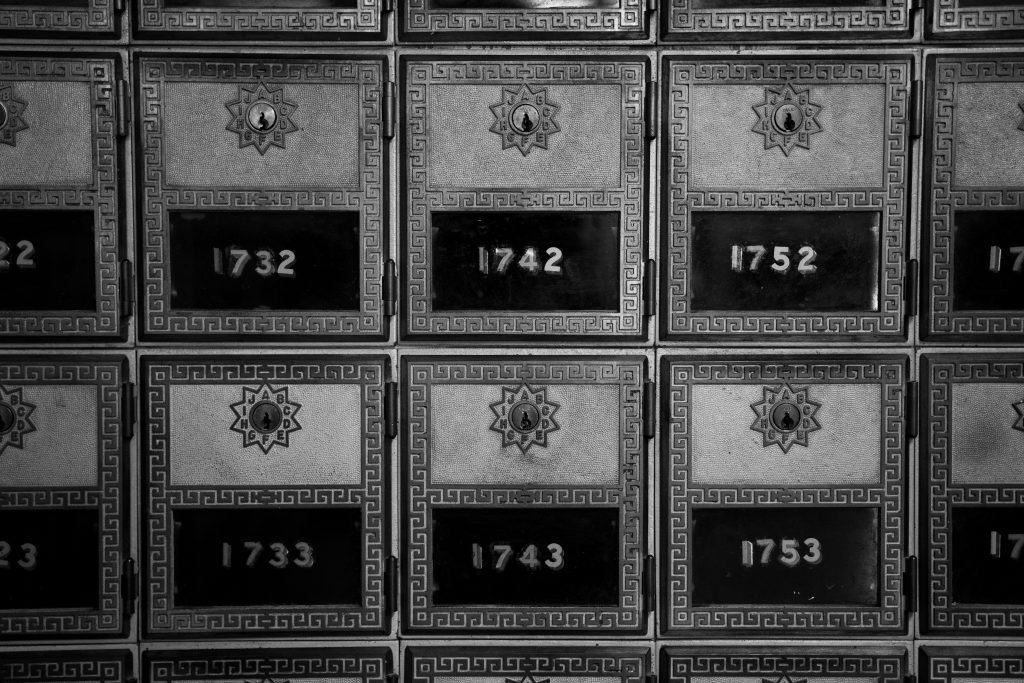 Row of PO boxes with a key inserted, symbolizing the process of submitting IRS Form 2553​