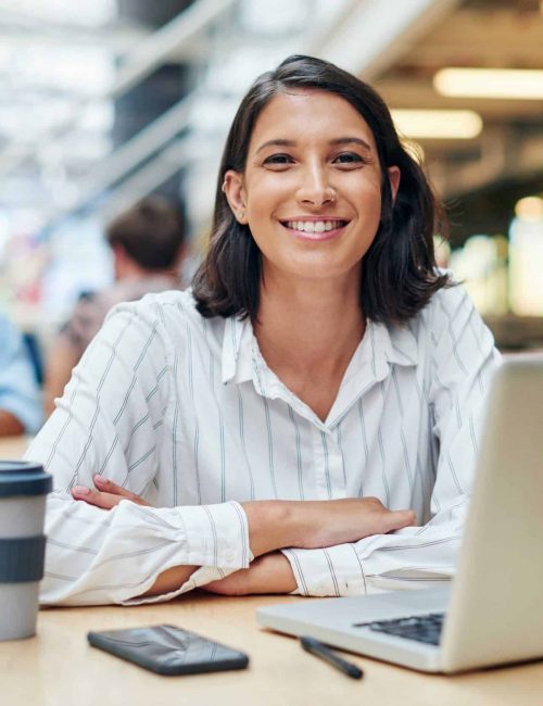 On target for month end. Shot of a young businesswoman using a laptop in a modern office