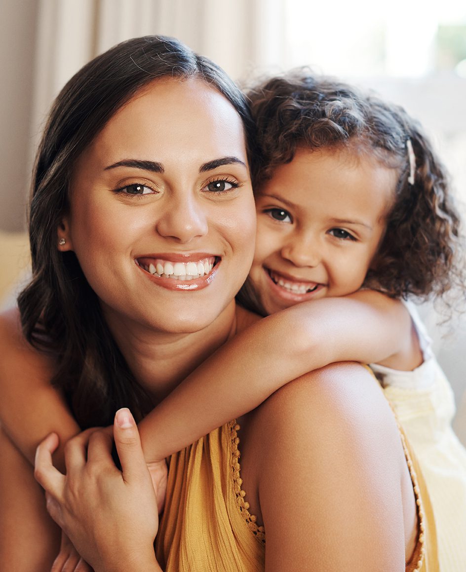 Shot of an adorable young girl hugging her mother in the living room at home