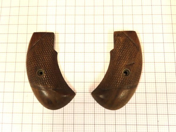 Pair of vintage wooden pistol grips with textured surface, designed for Colt 1911 firearm.