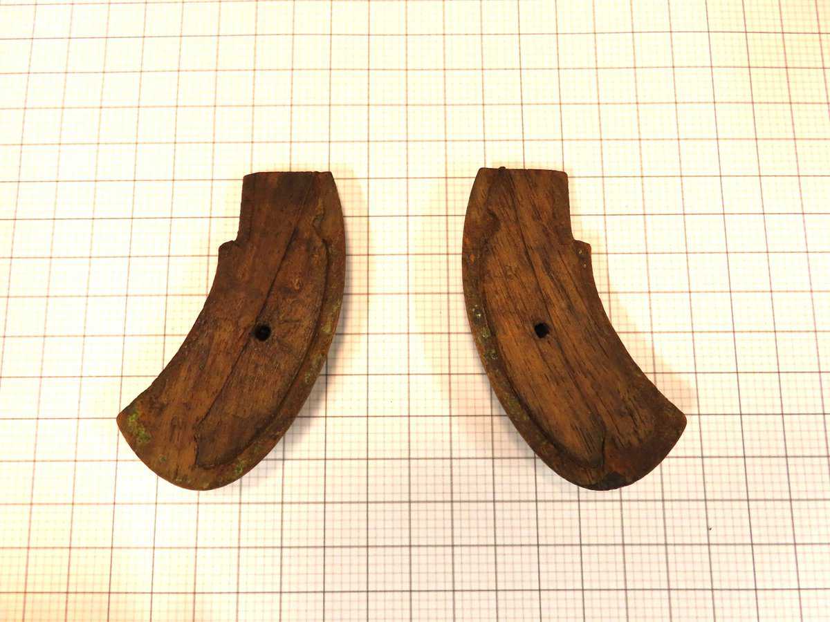 Antique wooden grips for vintage firearms, used in historical firearm craftsmanship.