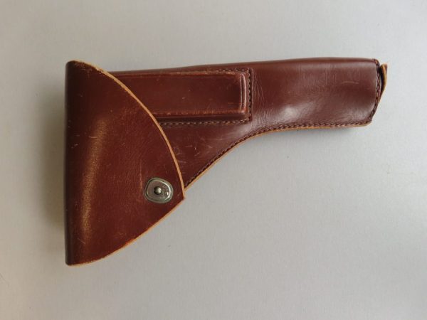 Leather gun holster with retention strap, ideal for shooting sports and hunting.