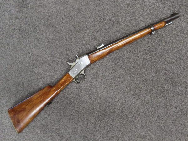 Antique lever-action rifle with wooden stock and metal barrel, ideal for firearm collectors and aficionados.
