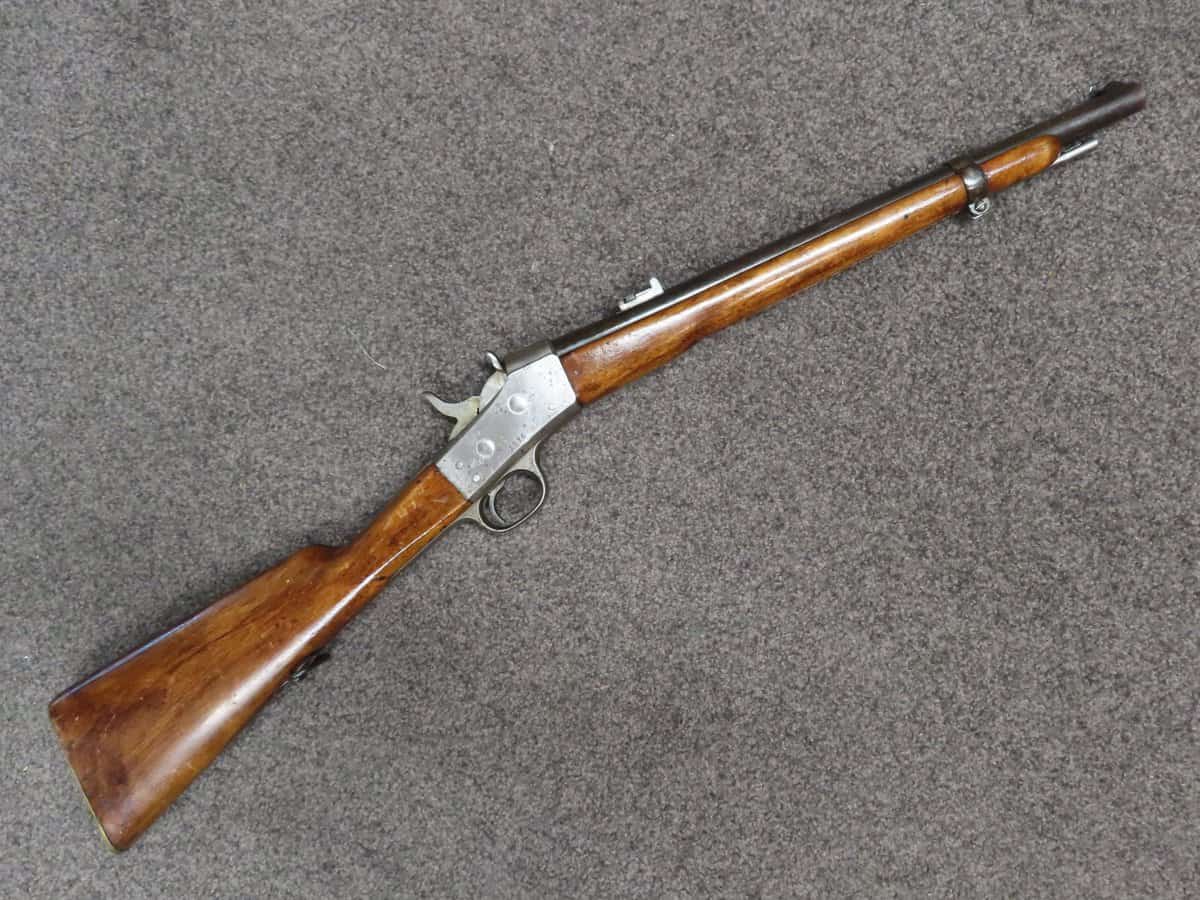 Antique lever-action rifle with wooden stock and metal barrel, ideal for firearm collectors and aficionados.