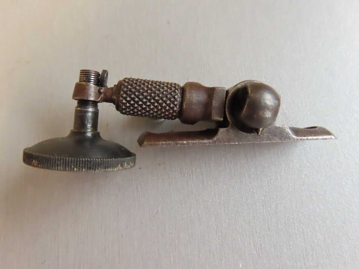 Machinery for firearm reloading, vintage brass tool for ammunition production, metalworking equipment.