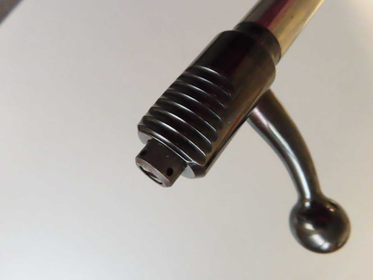 Close-up of a firearm muzzle brake featuring a spiral design and metal finish, from Colonial Ammunition Company NZ.