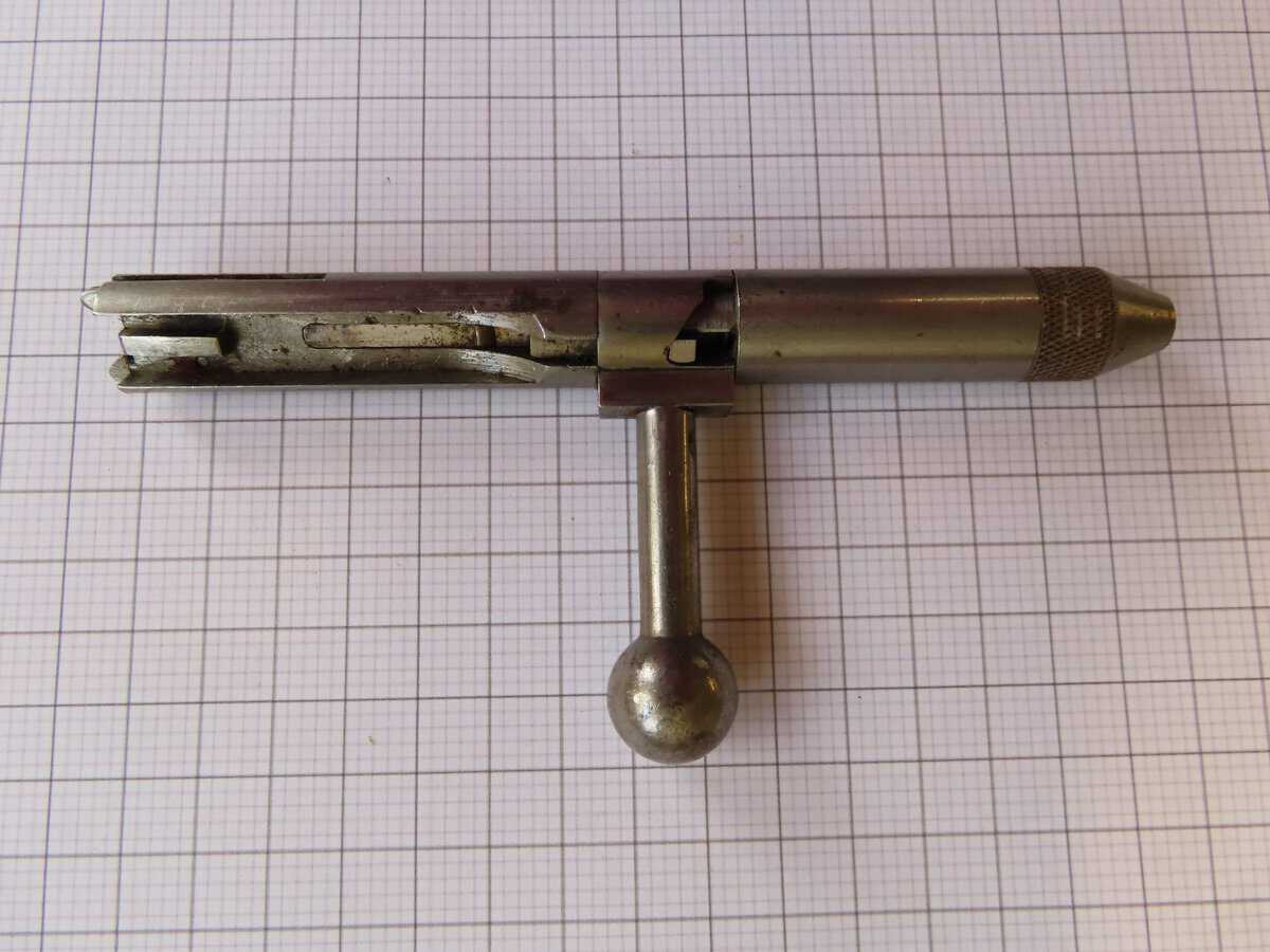 Antique firearm cleaning rod with handle, used for gun maintenance.