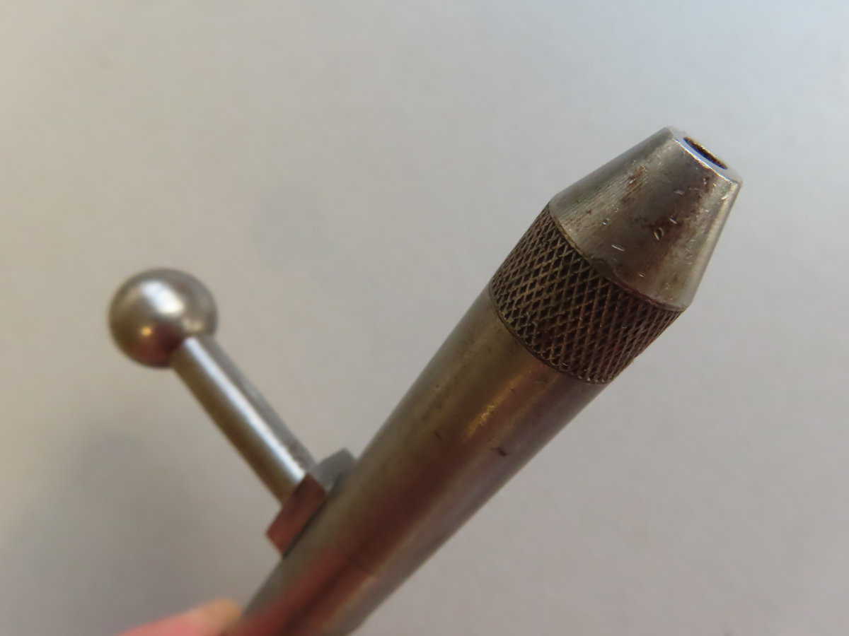 Antique metal ammunition tool used in firearms for ammunition testing or cleaning.