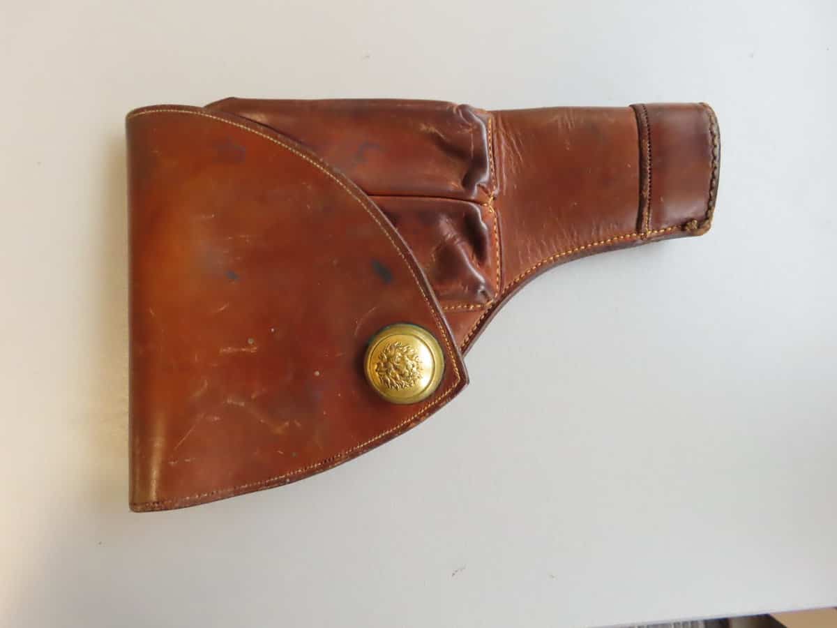 Leather ammunition holster with brass detail, designed for classic firearm enthusiasts.
