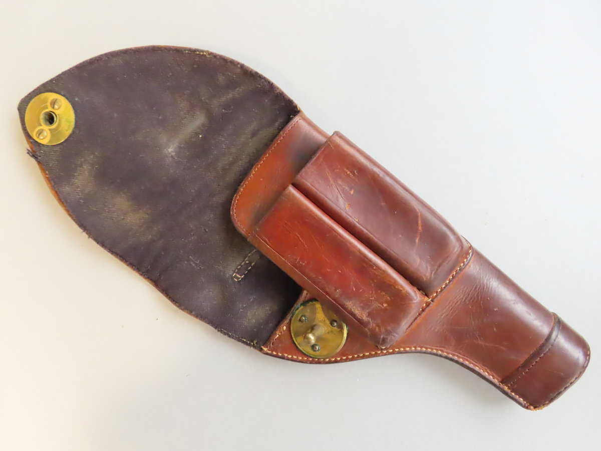 Durable brown leather ammo holder with brass fasteners, perfect for hunting or historical firearm displays.