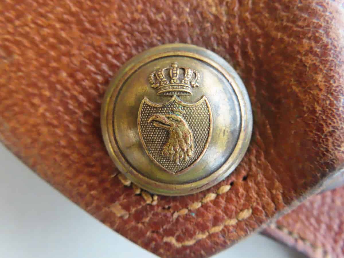 Old colonial badge featuring eagle emblem and crown, associated with the Colonial Ammunition Company NZ.