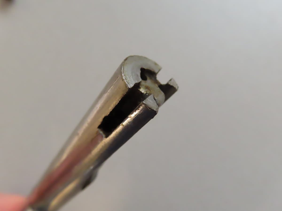 Close-up of an old Colt revolver firing pin, showing detailed metal craftsmanship and vintage firearm repair.