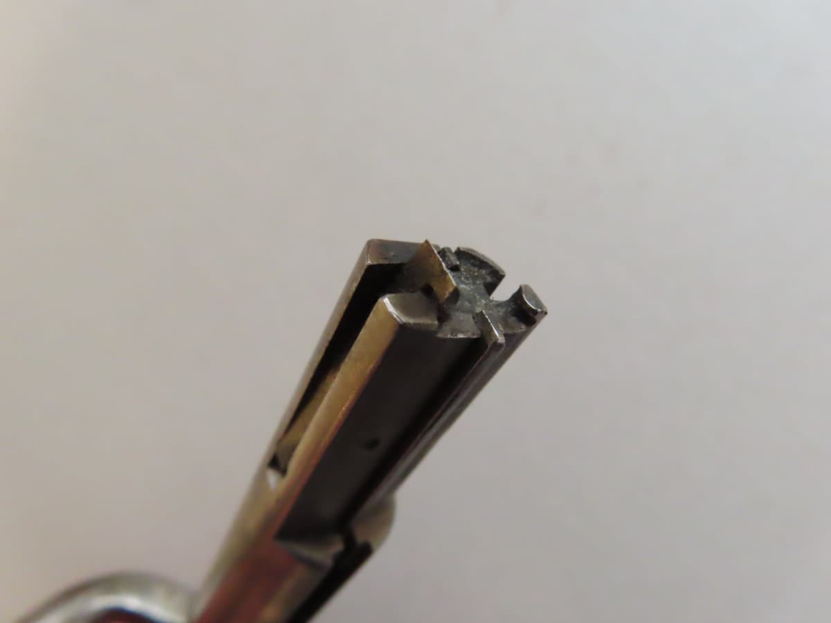 Detailed close-up of a vintage firearm barrel from Colonial Ammunition Company, reflecting NZ's historic gun manufacturing and ammunition history.