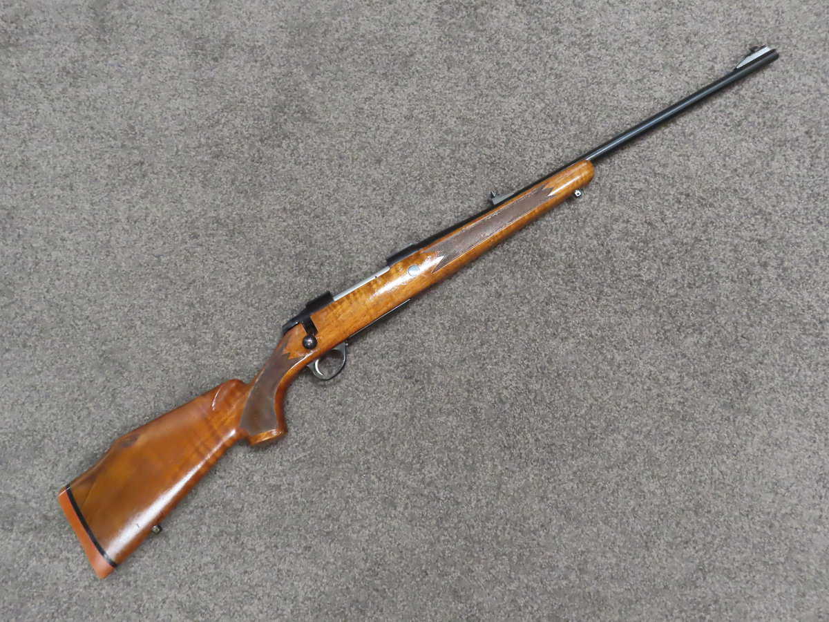 Classic bolt-action rifle with wooden stock, suitable for collectors and firearm enthusiasts.
