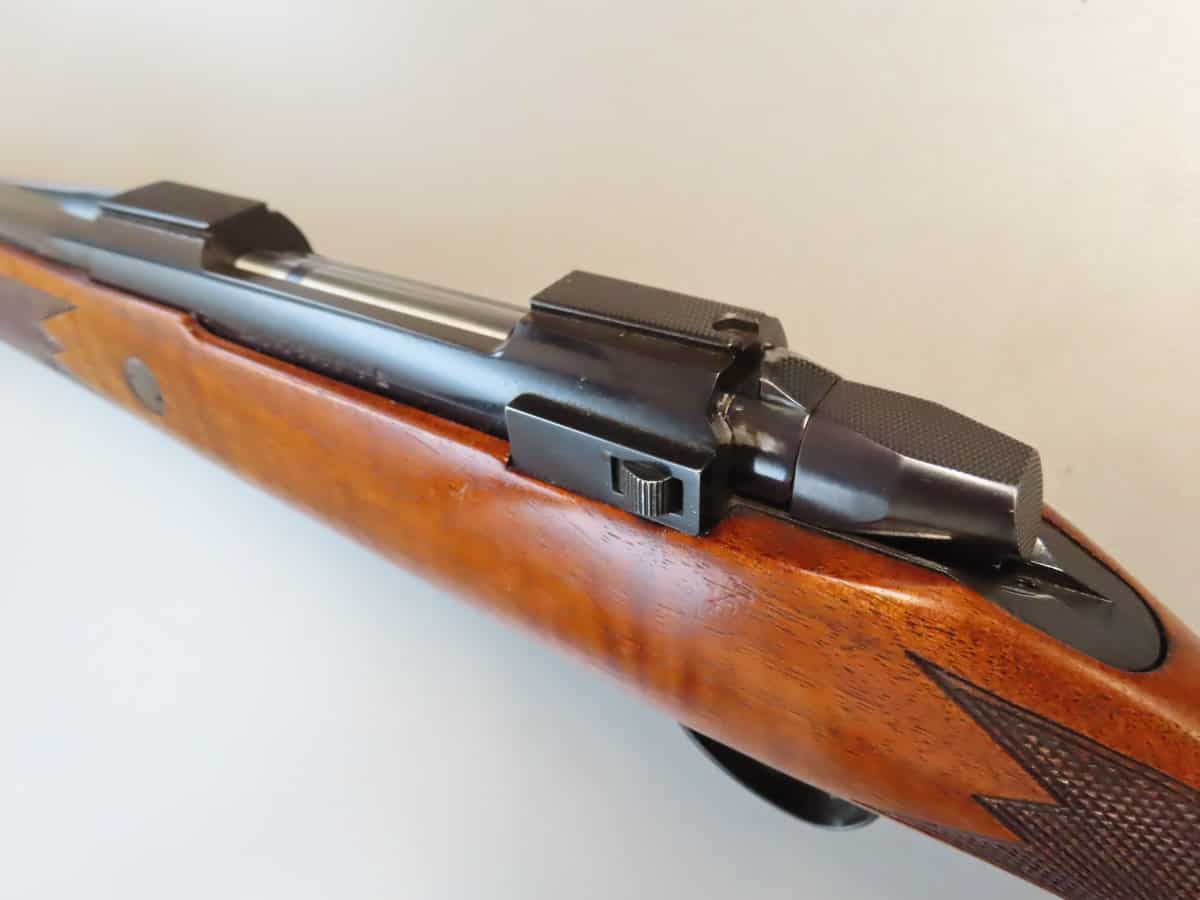 High-quality image of a classic bolt-action rifle showcasing wood grip and precision engineering.