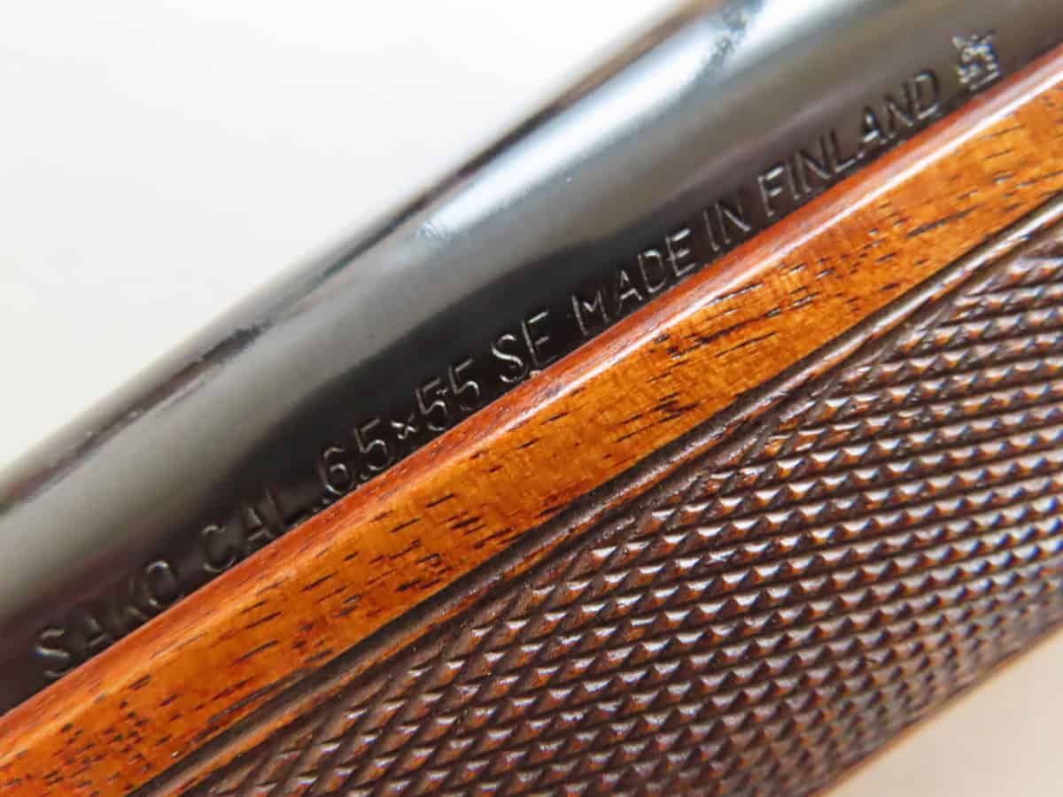 High-resolution close-up of a firearm barrel's engraved markings, emphasizing quality and historical elegance from Colonial Ammunition Company, NZ.