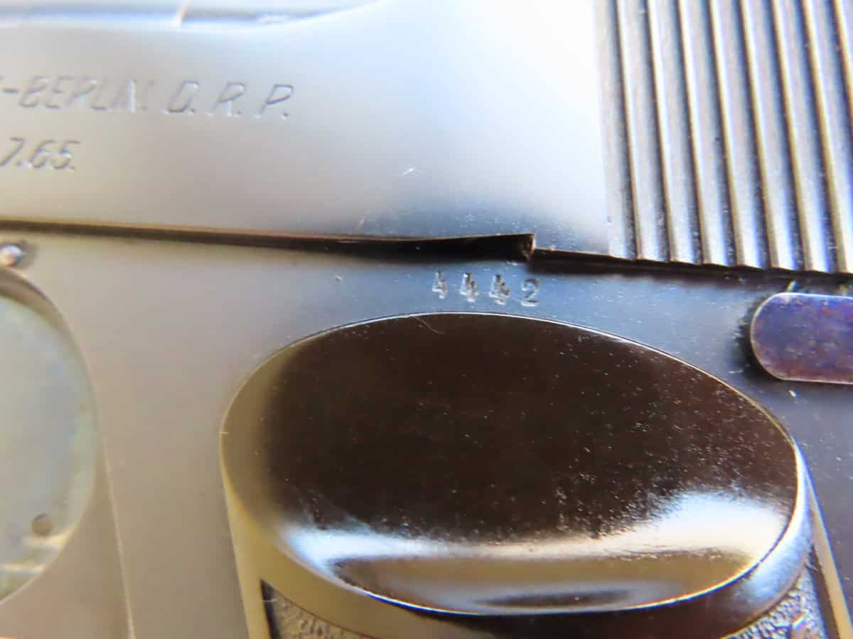 Close-up of serial number and metal engraving on a classic firearm by Colonial Ammunition Company.