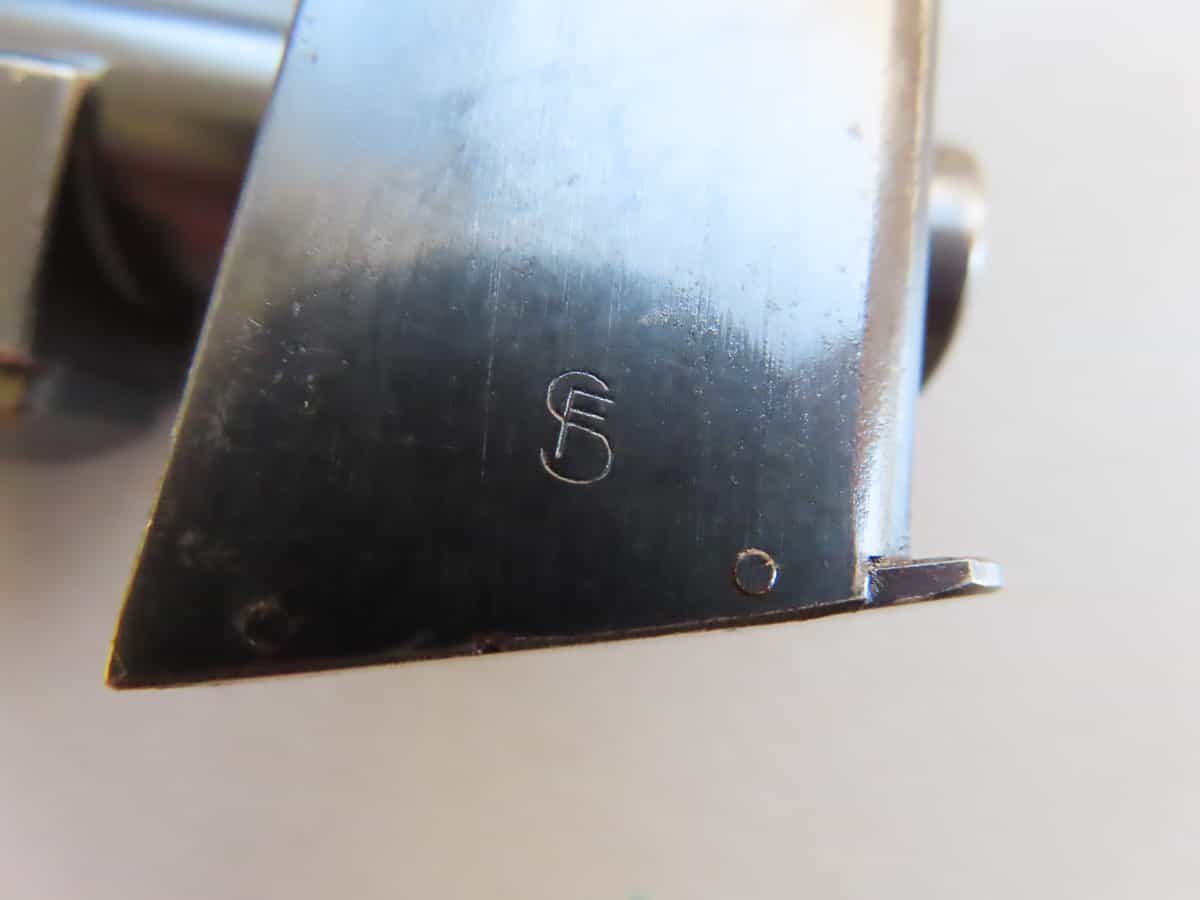 Close-up of vintage ammunition metal part with engraved mark, used by Colonial Ammunition Company NZ.