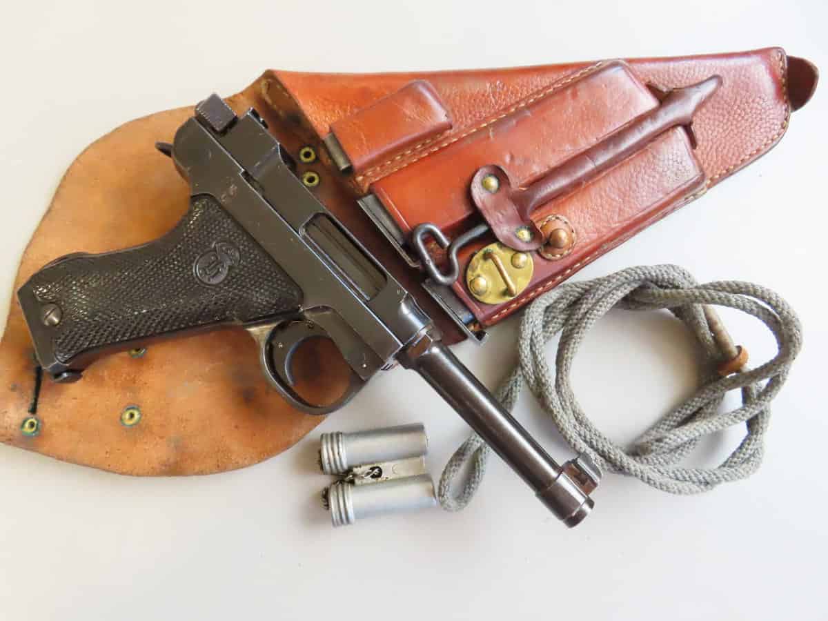 Old pistol with leather holster, bullets, and rope, showcasing historic firearm accessories by Colonial Ammunition Company NZ.
