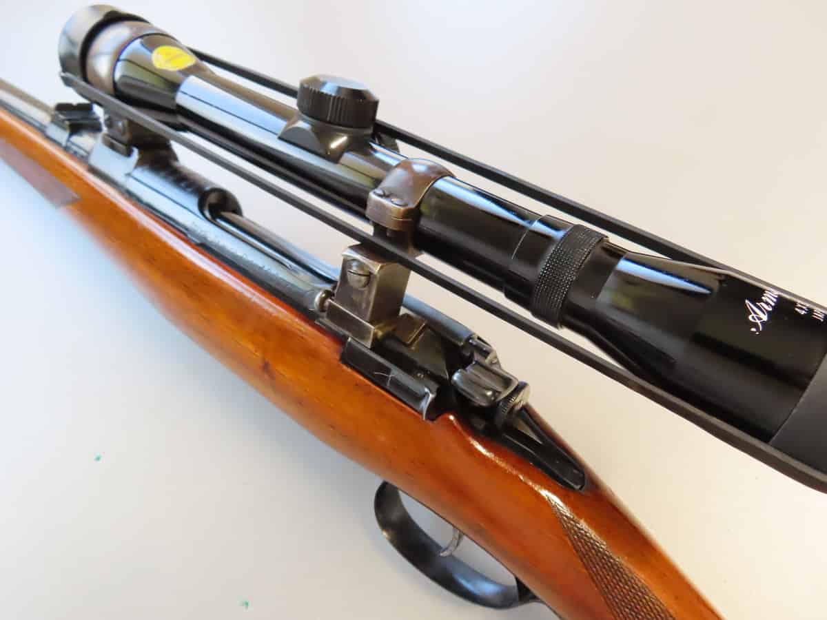 Close-up of a rifle with a mounted scope, highlighting shooting equipment and firearm precision.