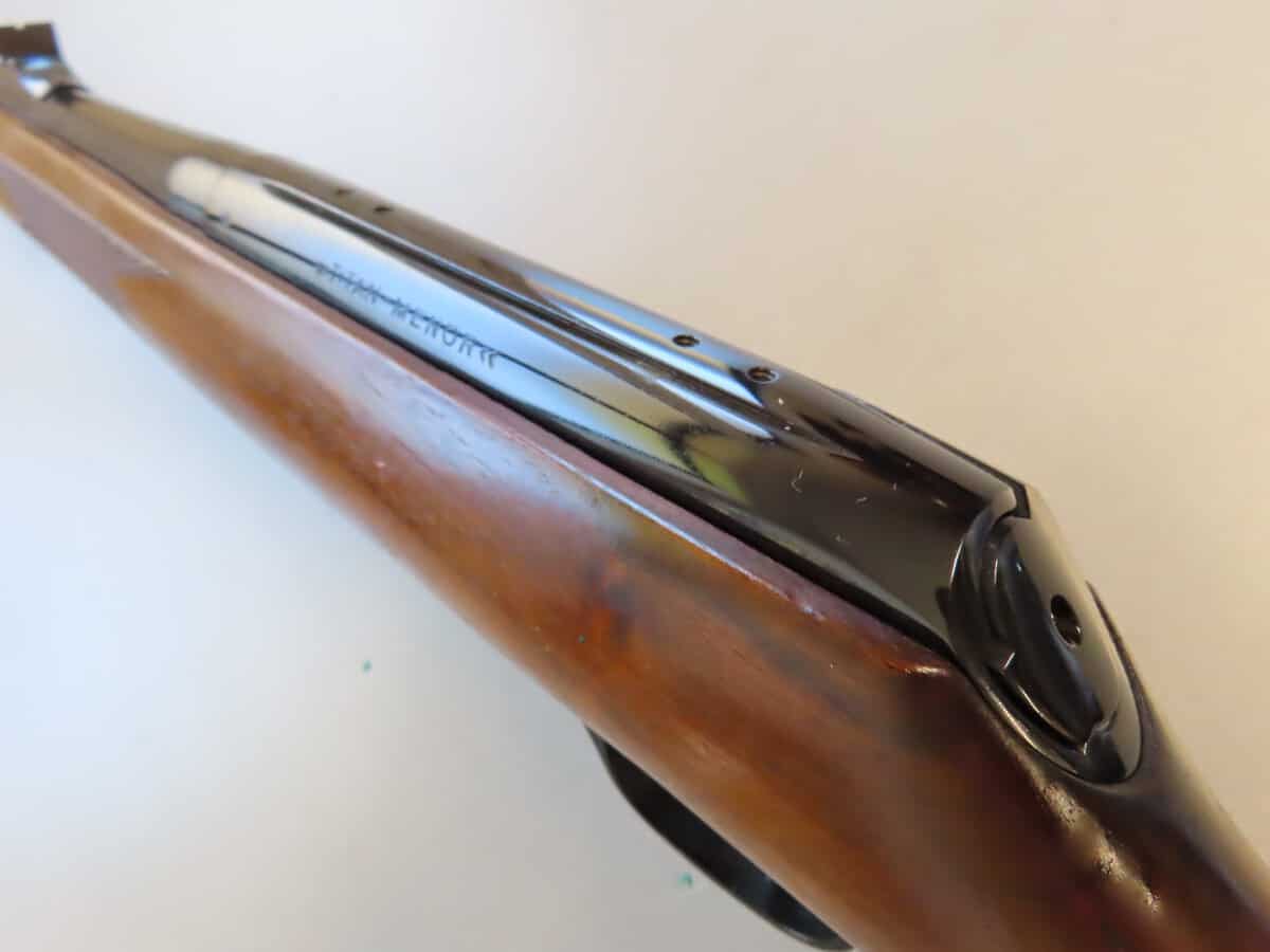 Rifle with glossy metal barrel and wooden stock, showcasing heritage firearms from Colonial Ammunition Company.