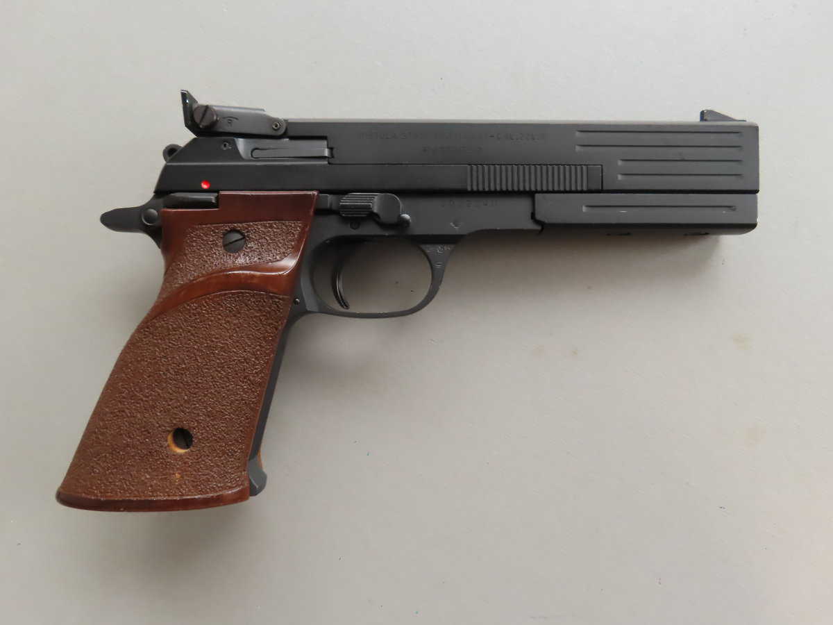 Black semi-automatic pistol with brown textured grip, used for shooting sports or collection.