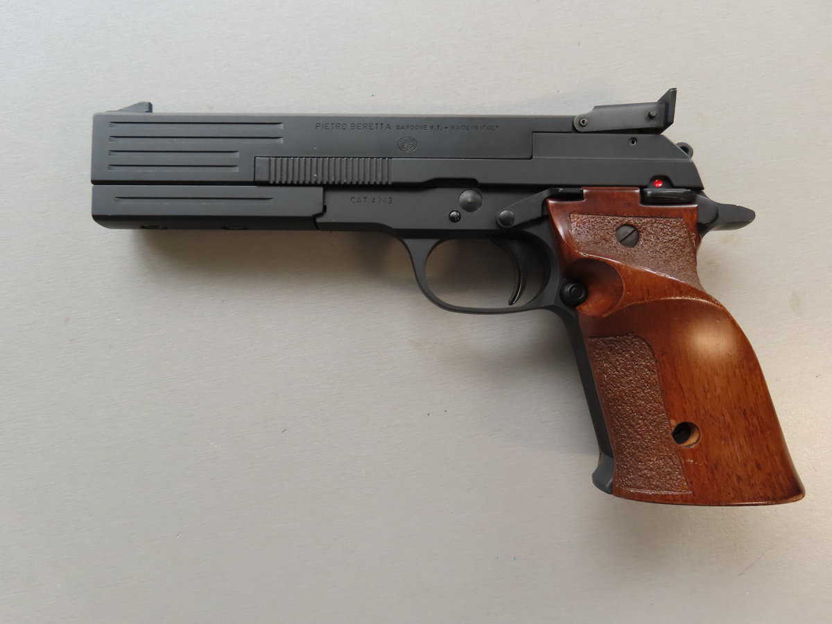 Image of a black semi-automatic handgun with a wooden grip, typical of the Beretta model.