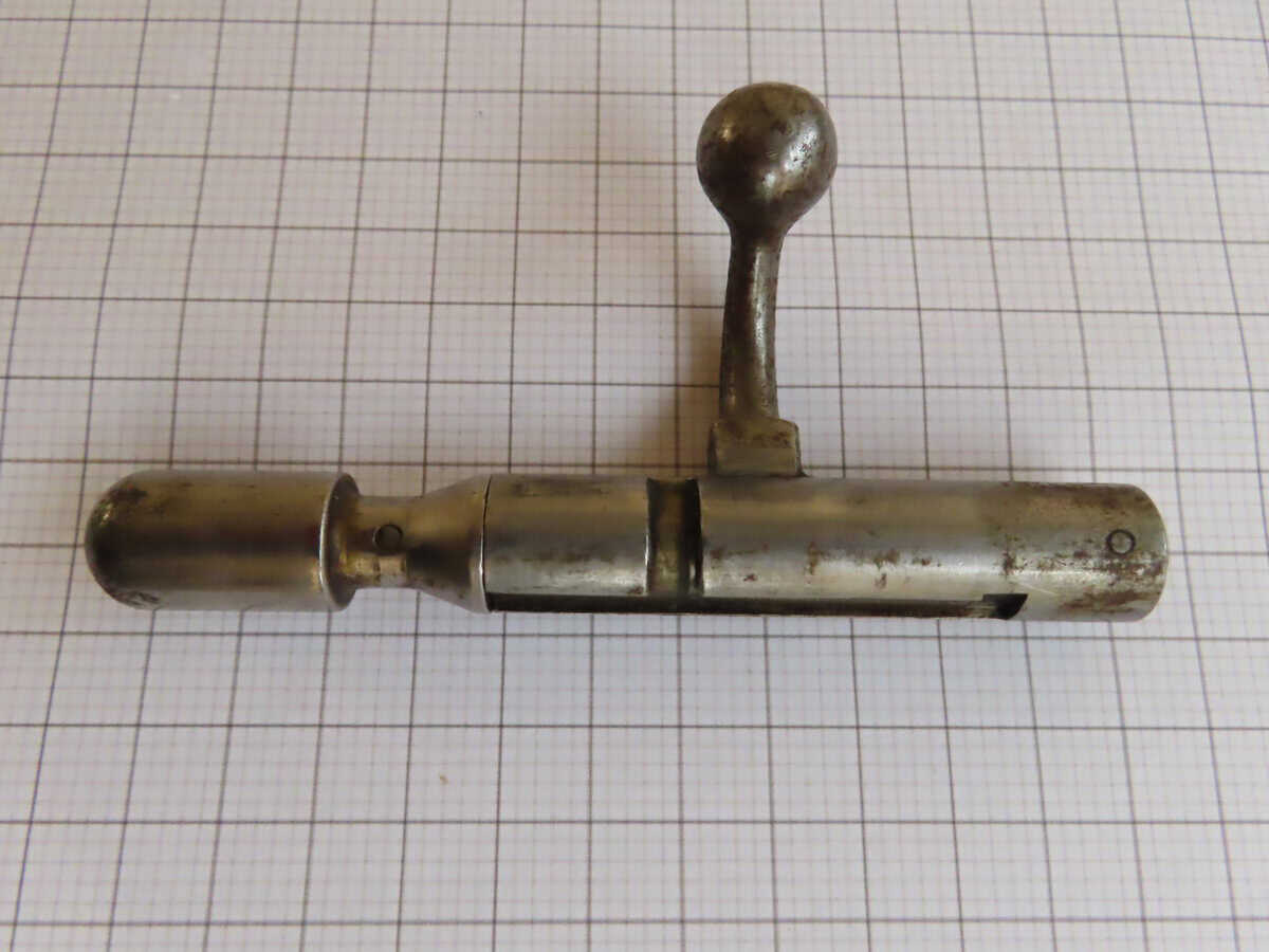 Old steel firearm loading tool, vintage Colt Revolver component, antique military ammunition equipment.