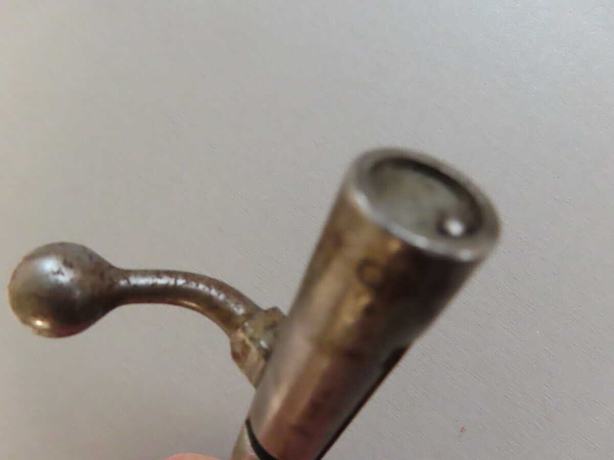 Antique metal cleaning rod or gun cleaning tool, used for firearm maintenance and cleaning.