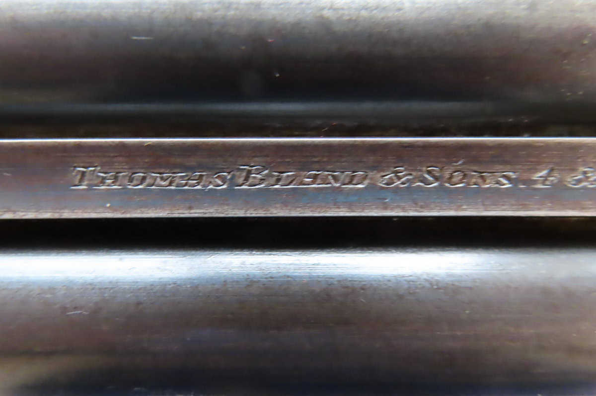 Vintage firearm serial number engraving, military-style, in close-up.