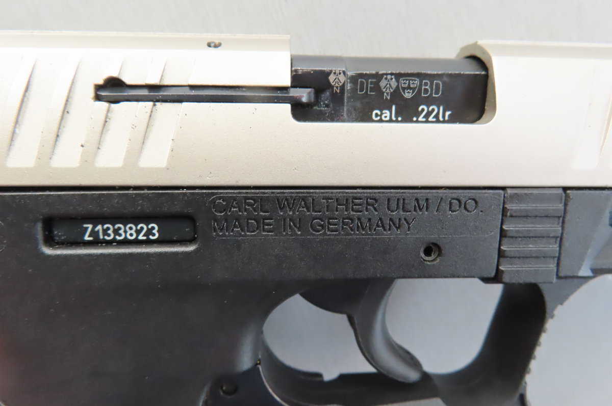 Detailed close-up of vintage firearm with "cal. .22lr" marking showing ammunition history.