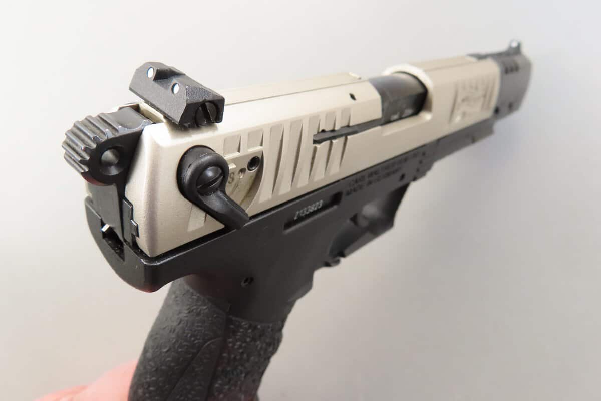 Close-up of a modern pistol with tactical features, suitable for firearm enthusiasts and shooting sports.