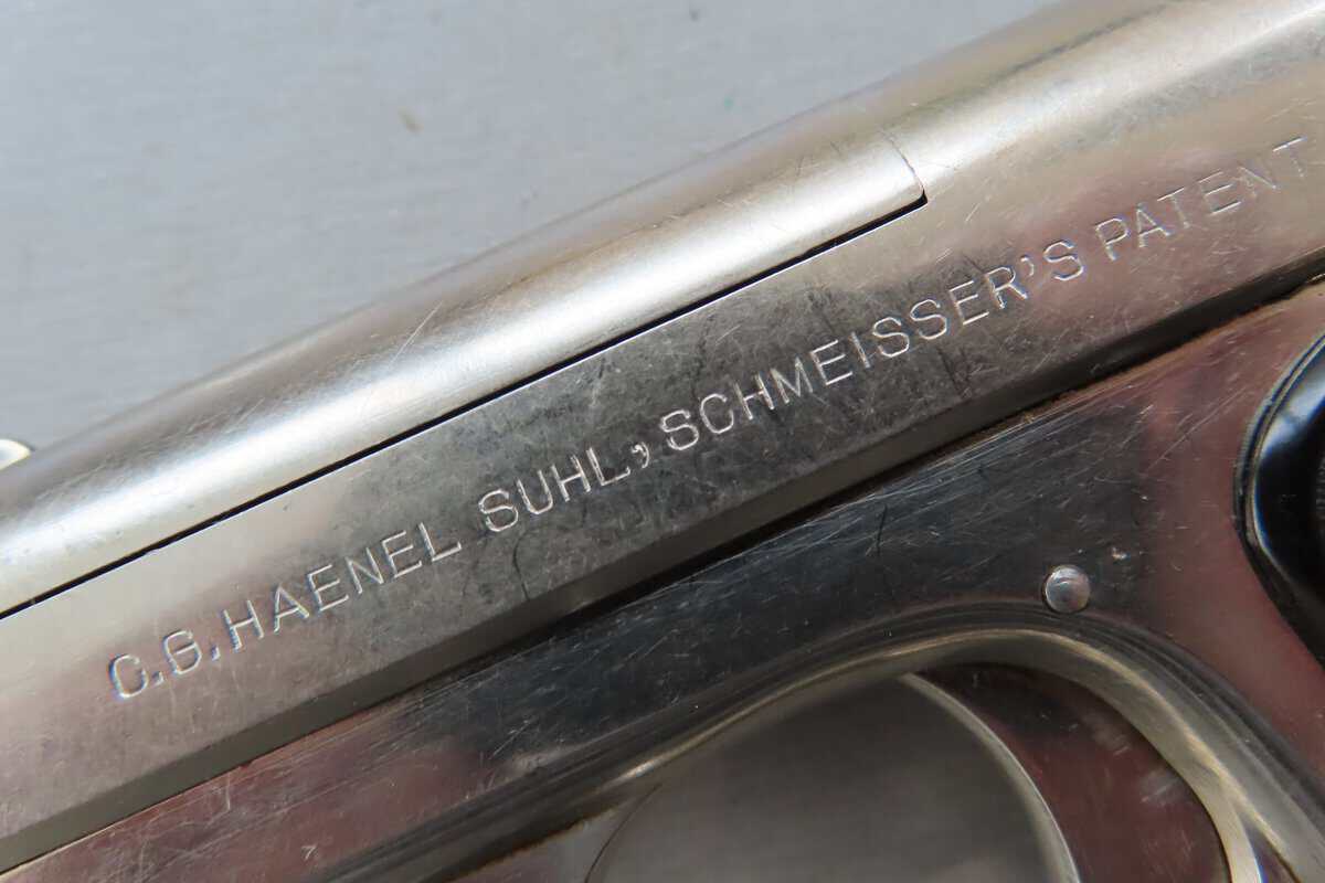 Close-up of vintage firearm serial number and manufacturer mark, showcasing quality craftsmanship.
