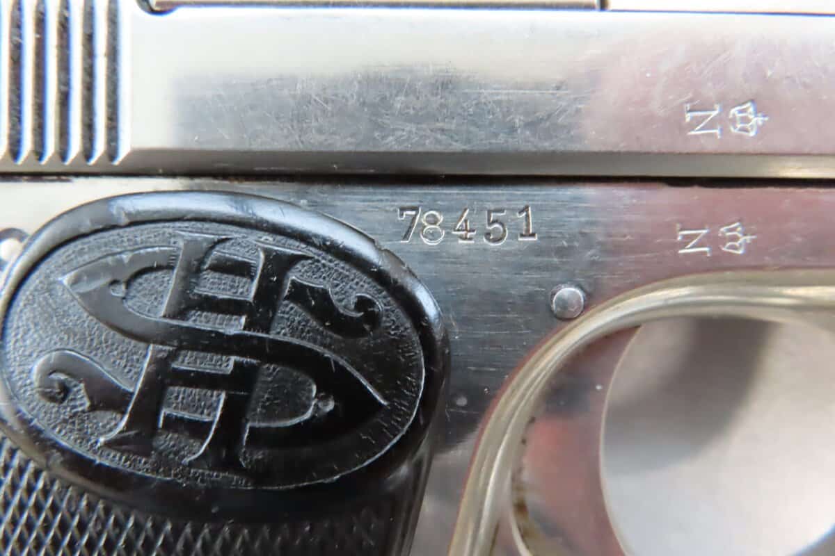Close-up of firearm serial number near Colonial Ammunition Company logo and markings.