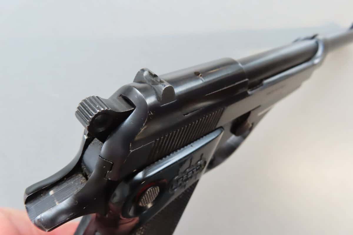 Close-up of a semi-automatic handgun, highlighting firearm mechanics.