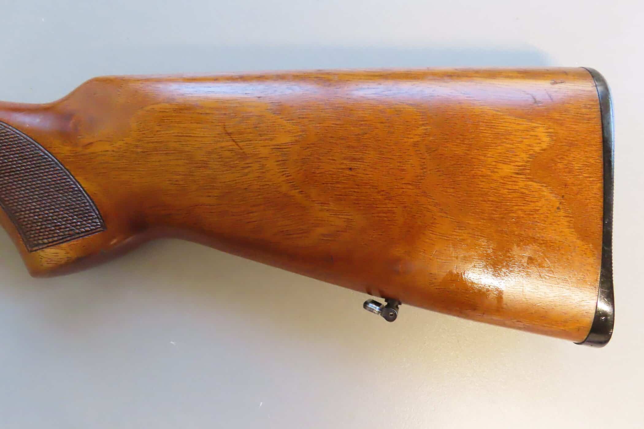 Old wooden firearm stock, part of colonial ammunition and firearm collections in New Zealand.