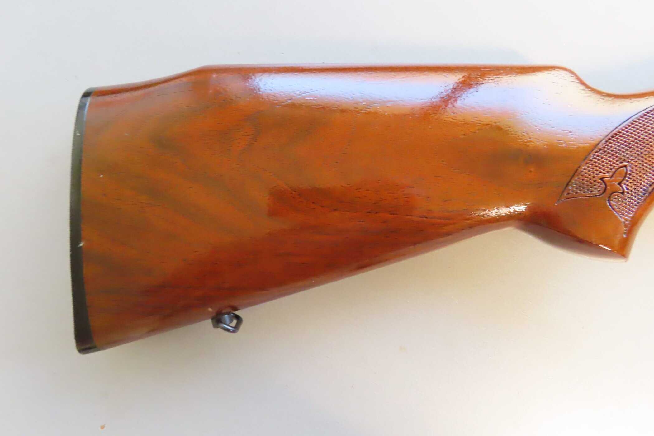 Wooden firearm stock with detailed checkering and vintage finish for Colonial Ammunition NZ.