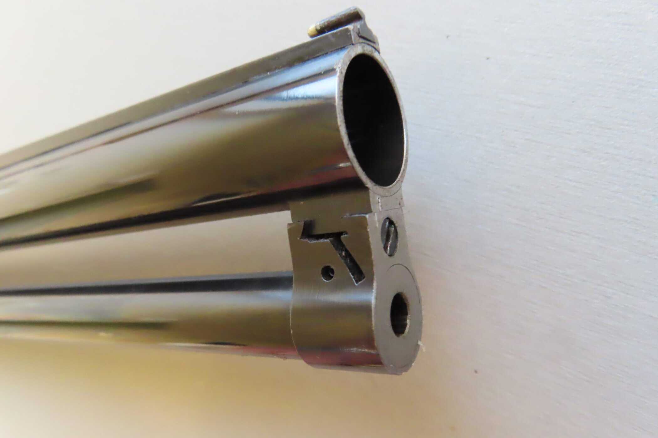 Sharp image of a polished metal firearm barrel, focus on the muzzle, from Colonial Ammunition Company NZ.