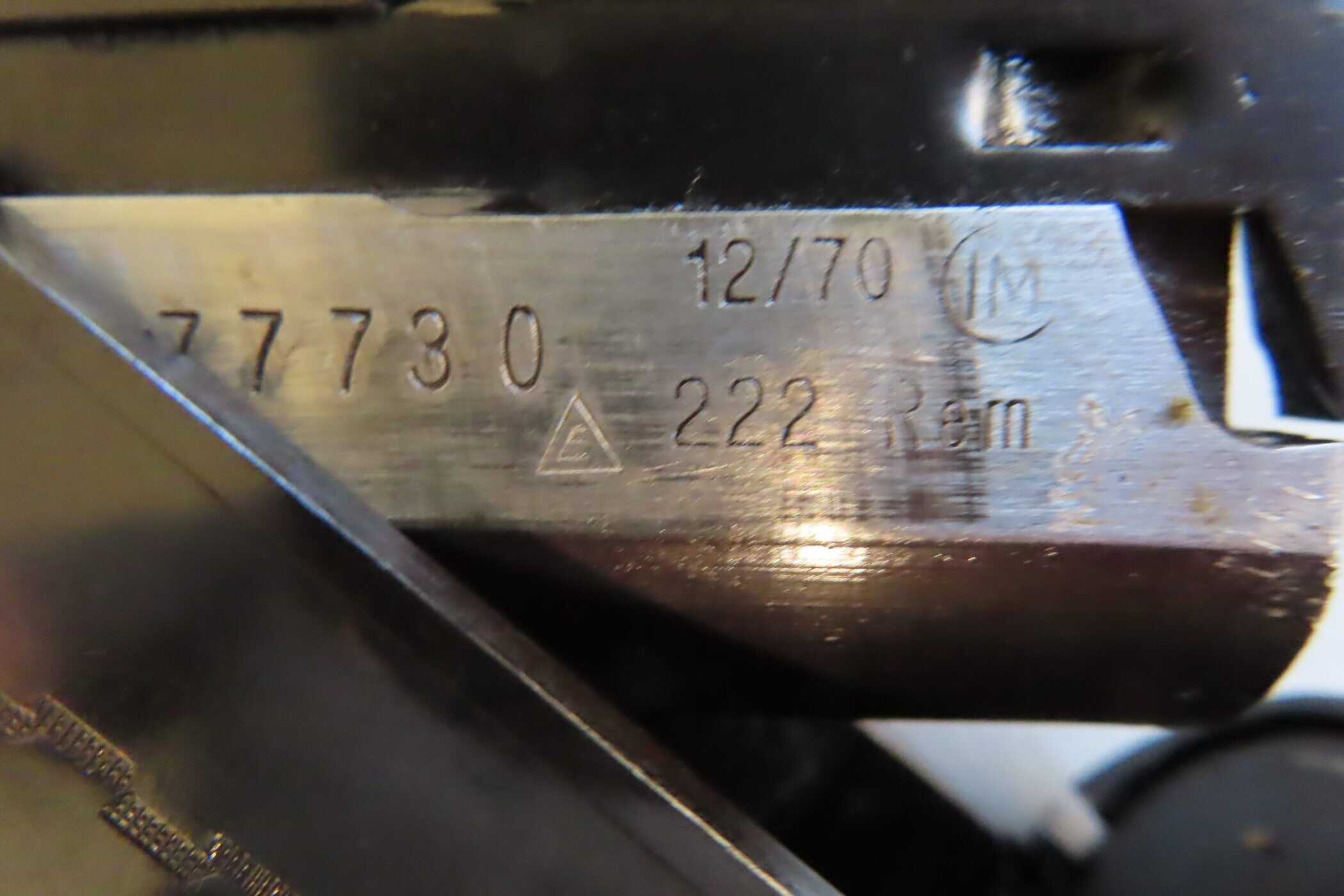 A close-up of serial numbers and markings on a firearm component, associated with Colonial Ammunition Company in New Zealand.