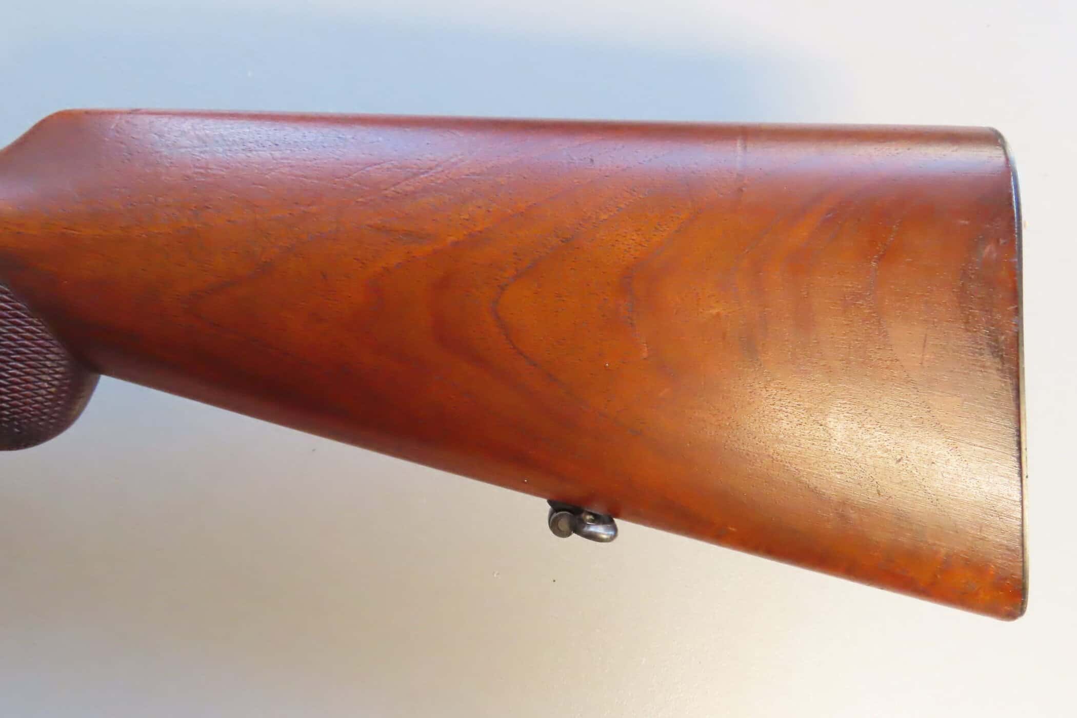 Antique wooden gun stock showcasing craftsmanship, part of Colonial Ammunition Company's collection.