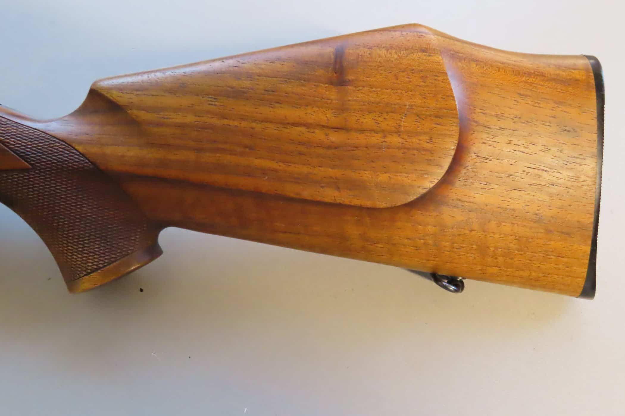 Handcrafted wooden rifle stock, ideal for hunting guns or ammunition displays.