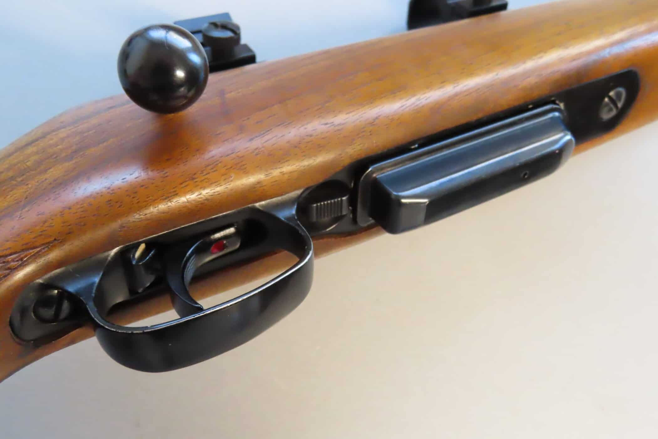 Antique rifle with wooden stock and metal trigger, showcasing historical firearm craftsmanship.